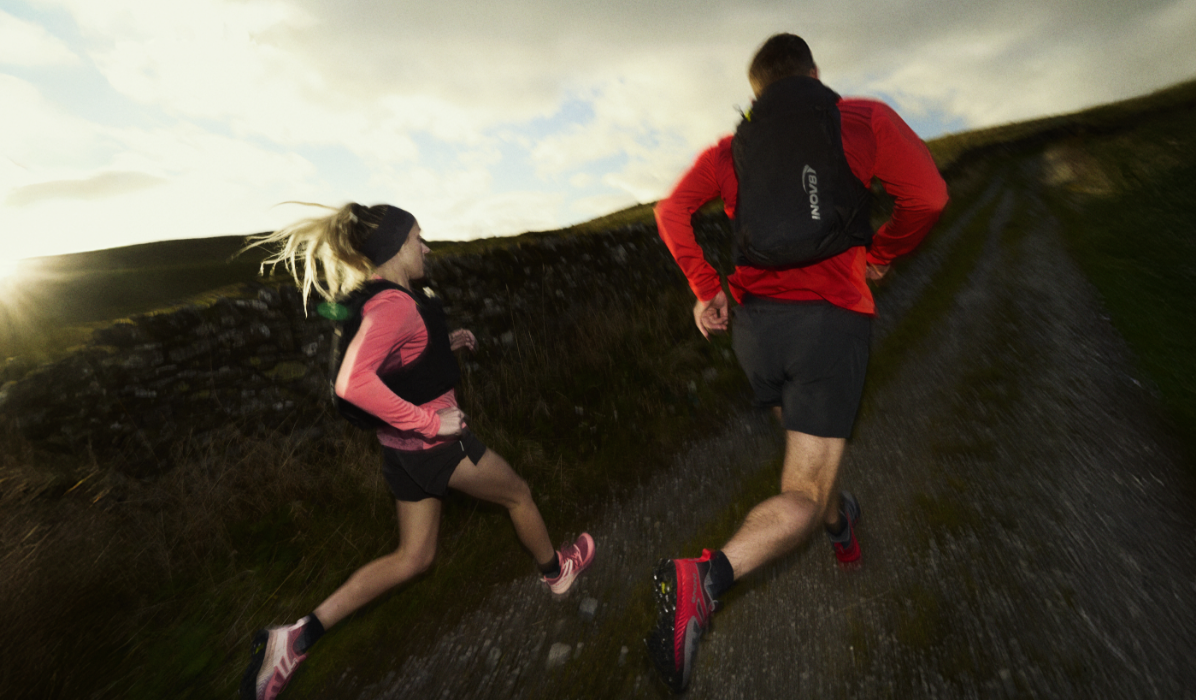 man and woman running on dirt road