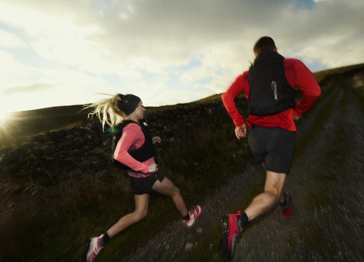 man and woman running on dirt road