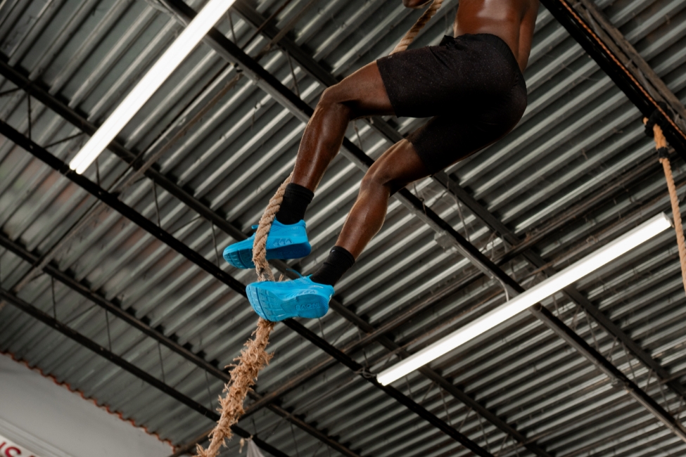 Hybrid athlete climbing a rope